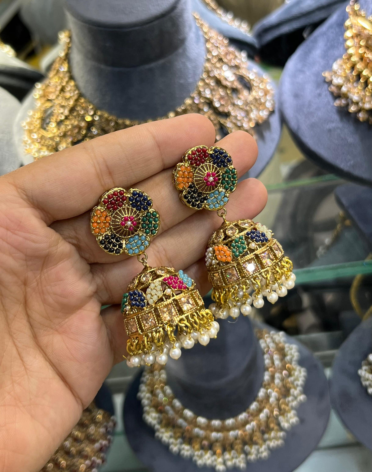 Antique gold jhumka earrings with navratan multicolour stones and pearl drops