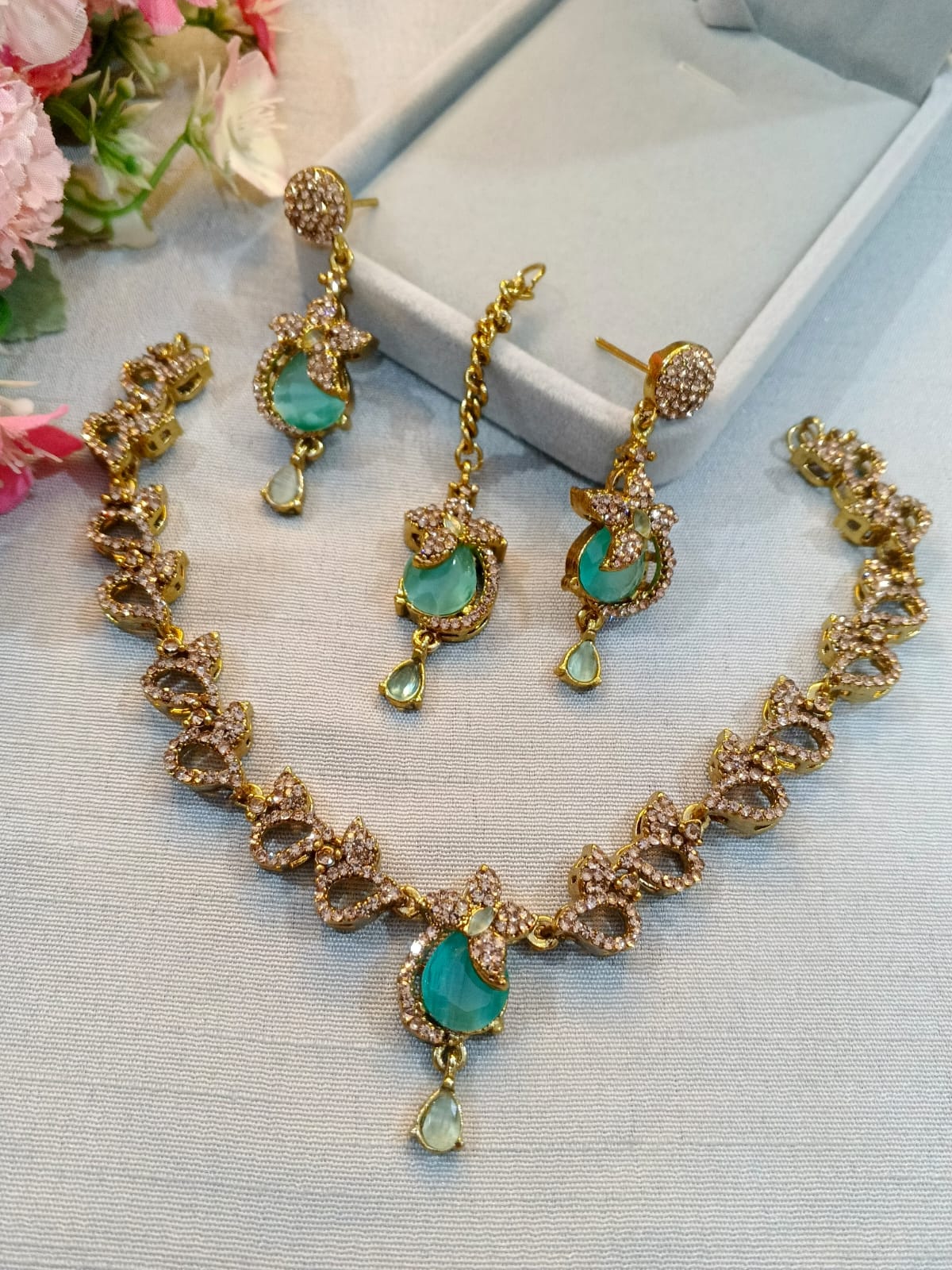 Brown polish zircon necklace set with earrings and tikka, mint green stones