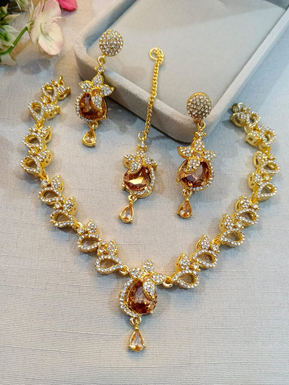Gold polish zircon necklace set with earrings and tikka, champagne stones