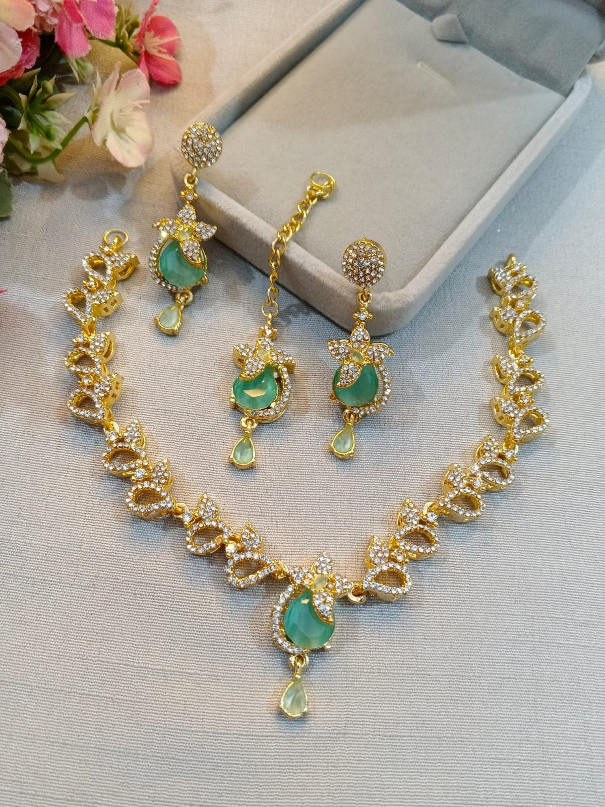 Gold polish zircon necklace set with earrings and tikka, mint green stones
