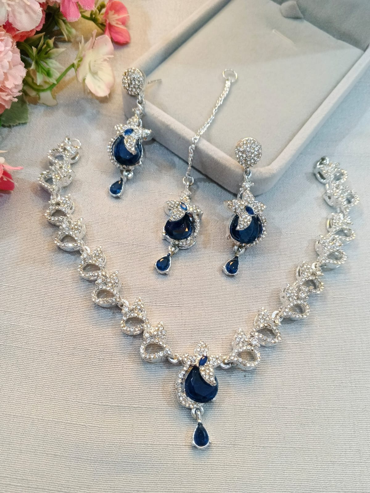 Silver zircon necklace set with earrings and tikka, navy blue stones